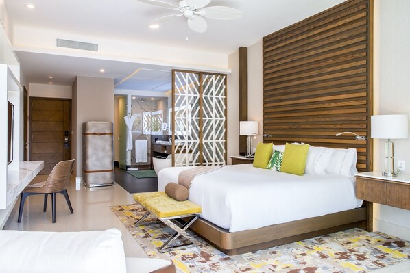 Garza Blanca Cancun: elegant suite with king bed, modern bathroom, and seating.