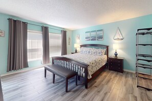 Primary bedroom features a king bed with balcony access and en-suite bathroom