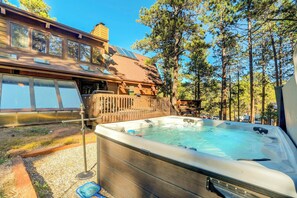 Unwind in the hot tub surrounded by serene forest views—your private outdoor retreat awaits.