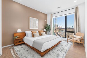 Bedroom #2 with a plush King bed, river view, closet, and room-darkening shades