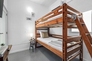 Chic minimalist bedroom with a stylish wooden bunk bed, perfect for urban explorers.