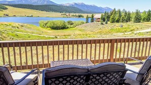 Experience pure awe on the back deck at Mountain Lake Lodge, where stunning views of the lake, trees, and mountains create a picturesque backdrop. It's nature's masterpiece unfolding before your eyes.