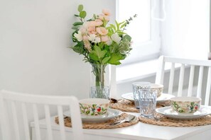 A beautifully set dining table with fresh flowers, elegant glassware, and a cozy ambiance for a delightful meal.

