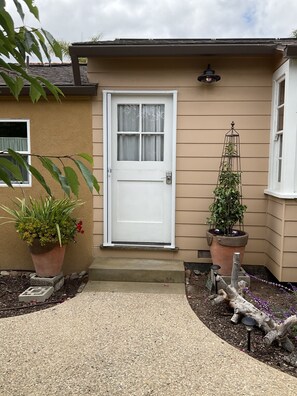 Casita front door located beyond the gate and in the garden