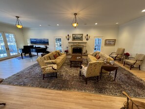 Living Room with wood burning fireplace and grand piano..