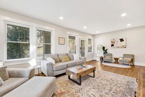 A spacious living area adorned with plush sofas and tasteful décor, creating an ideal space for relaxation and gatherings with loved ones.