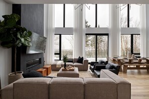 Living room with ample seating, fireplace and views