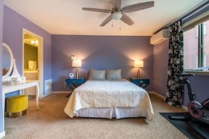 Another view of the cozy master bedroom. Nice area to the left to do your makeup while sitting on a cool yellow ottoman.