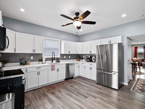 Bright and airy kitchen with stainless steel appliances and granite countertops.