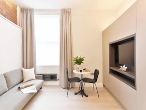 Living room area, with comfortable wall bed. Latest technology system, easy to use and space efficient to enjoy as much as possible your stay. The wall bed can be easily folded into a comfortable sofa for your commodity.