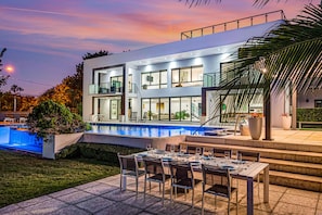 Many outdoor lounge areas, overwater dock and oversized pool - ideal this villa is the quintessence