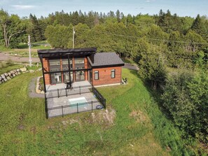 Charming modern cabin surrounded by lush greenery and open space