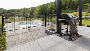 Outdoor grill area next to the fenced private pool for fun cookouts