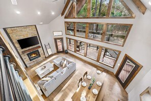 The custom wood finishes, high ceilings, and modern decor create a rustic and comfortable ambiance.