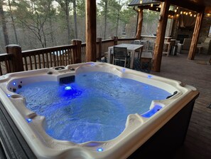 Embrace the serenity of twilight from our cabin hot tub, where the day's worries melt away in the soothing waters