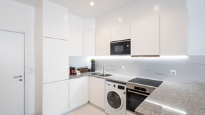 Effortless elegance awaits in our clean and white kitchenette. Experience the charm of simplicity and functionality in this bright culinary space. #CleanKitchen #Simplicity