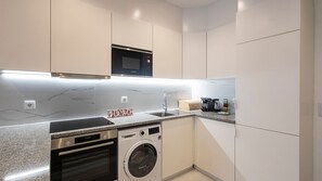 Effortless elegance awaits in our clean and white kitchenette. Experience the charm of simplicity and functionality in this bright culinary space. #CleanKitchen #Simplicity