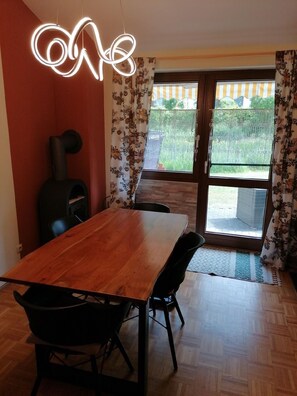 Dining area with romantic fireplace and view of the terrace