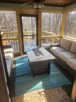 screened  in porch with gas fire pit