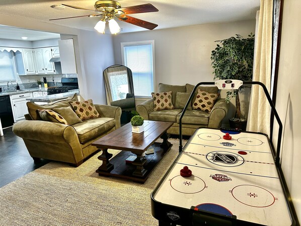 Living room, two comfortable heavy couches, large table, standing mirror