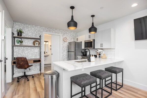 Fully-stocked modern kitchen with all the appliances and utensils you might need to enjoy a meal at home. Dedicated workspace available off the kitchen with high-speed internet throughout the condo.