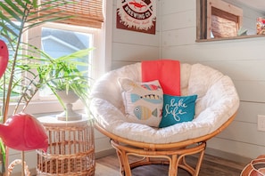 Curl up in this cozy cornerās papasan chair and read a book.