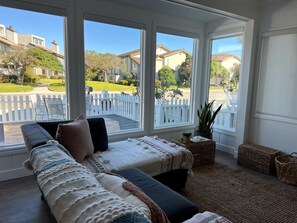 Living room space with long window view to front of house.