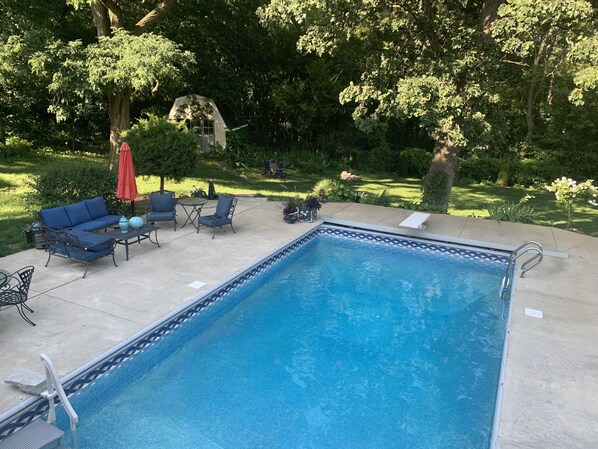 Backyard, heated pool with large patio and seating