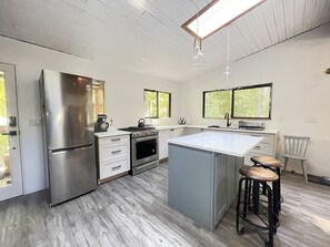 Newly renovated kitchen with gas stove.