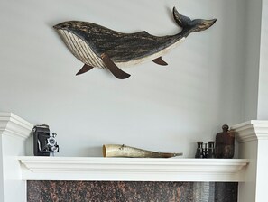 Local Artisan wood whale above fireplace