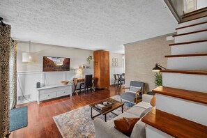 View of the living room as you head upstairs to the bedrooms and bathroom.