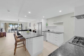 The kitchen centres around an island bench where you can sit and converse with the cook.