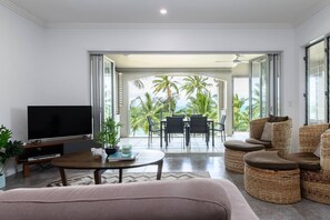 Relax in the spacious living area with balcony access and breathtaking beach views.