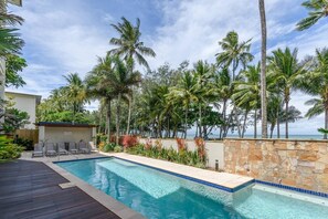 Take a refreshing dip in the inviting shared pool, perfect for a leisurely swim with peaking ocean views.