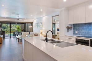 Elevate your culinary skills in the fully-equipped kitchen, where high-end appliances and ample space make meal preparation a breeze.