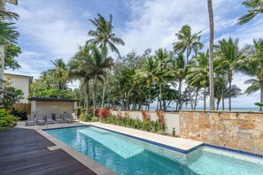 Enjoy a dip in the building's beachfront pool, with sun loungers and alfresco dining.