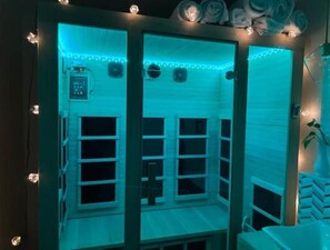 Sauna located in bathroom that’s attached to the living room