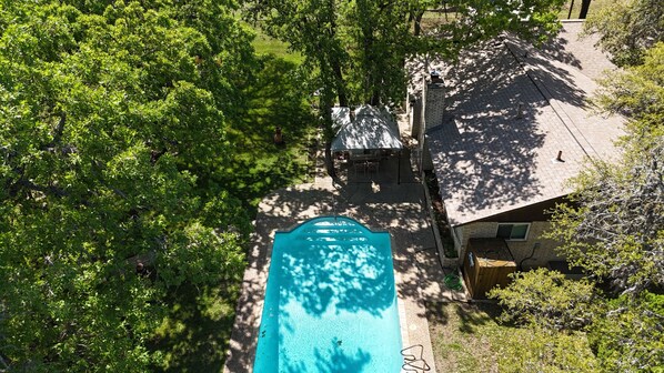 Large fenced in yard with mature oak trees to provide shade and privacy. 
