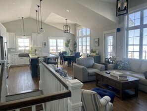 Open - living room, dining room and kitchen with 14' ceilings and wood floors.