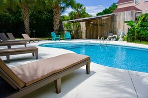 Large, private outdoor pool with plenty of lounge options