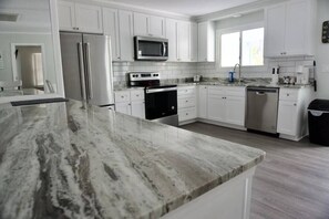 Beautiful open kitchen with new stainless-steel appliances