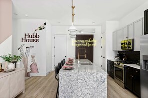 Clean and Spacious Kitchen with Sleek Countertops and Seating