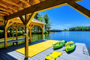Covered dock with kayaks and a swim platform, ideal for water activities and relaxation