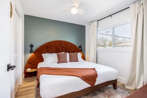 Bedroom #2 with a King bed, closet, Smart TV, ceiling fan, and room darkening shades.