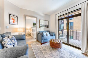 Living area with smart TV, gas fireplace and access to the private balcony