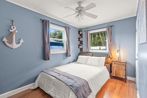 The second bedroom features a queen bed with a comfy frame and mattress. It's decked out with cozy linens and fluffy pillows for a restful night's sleep.