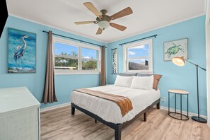 The third bedroom offers a comfortable queen-size bed with high-quality sheets and plenty of natural light.