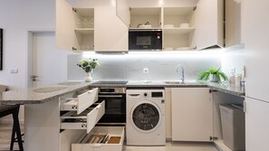 Effortless elegance awaits in our clean and white kitchenette. Experience the charm of simplicity and functionality in this bright culinary space. #CleanKitchen #Simplicity