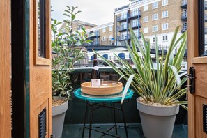 Double doors from main bedroom onto bow deck with outside seating and chairs