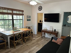 55" LED Smart TV and dining area for 4-5 people.